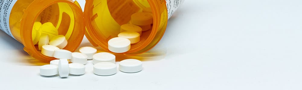 Oxycodone Addiction And Abuse oxycodone pills spilling on to table