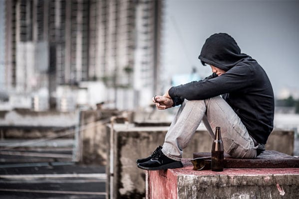 A young alcoholic man on a roof