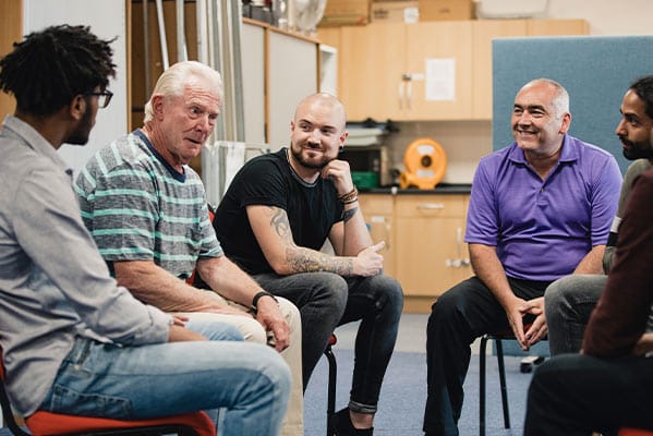 Men in a support group discussing their drug use