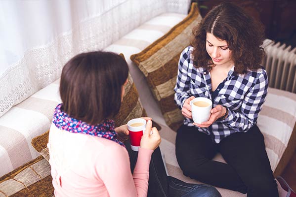 A young woman confides in her friend about her alcohol craving