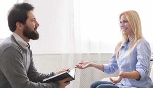 man and woman discussing the need for a depression treatment center 