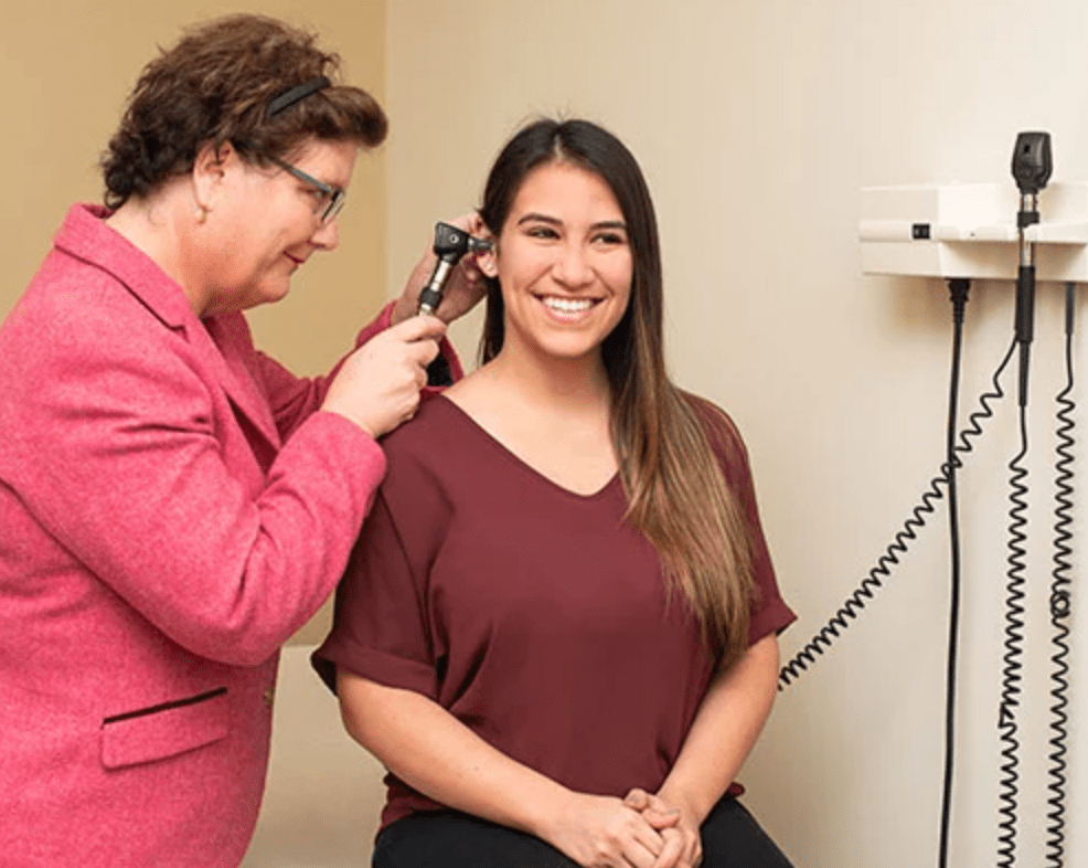 woman receiving ear examination in clinic