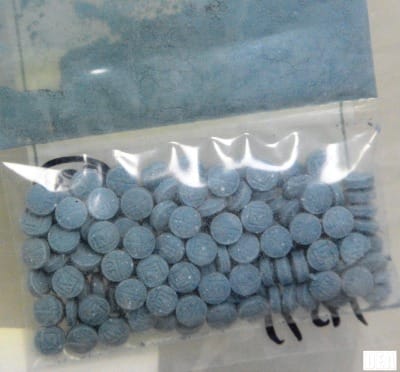 plastic bag full of blue fentanyl tablets