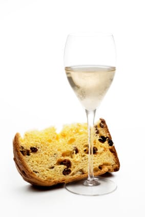 piece of cake next to a glass of sparkling wine