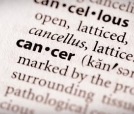 a closeup of the work cancer in a dictionary
