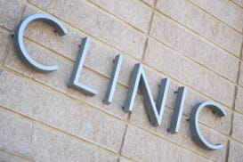 a detail of a sign that says clinic on the side of a building