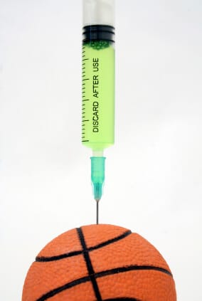 single use syringe injecting basketball with green liquid