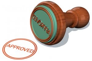 image of a rubber stamp that has stamped the word approved on a white background small