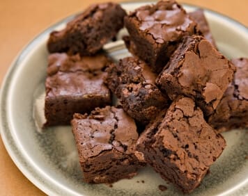 a pile of brownies on an earthenware plate