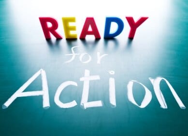 the phrase ready for action with ready spelled out in blocks and for action written in chalk on the surface below