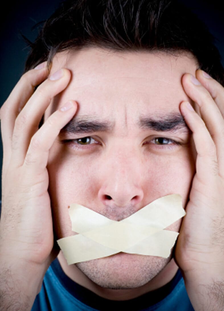 distraught man with hands on head and masking tape covering mouth