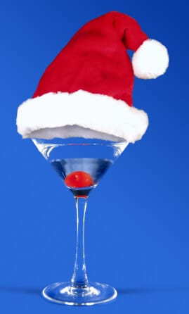 drink in a martini glass with a santa hat on top